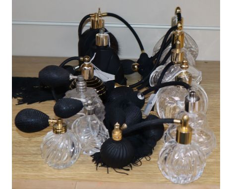 Five black glass and ceramic perfume atomisers and nine cut glass examples with black bulbs and tassels
