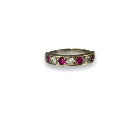 9ct London 1988 Gold Half Eternity Ring Comprising of five round cut diamonds and four round cut pink stones weighing 3.28 gr