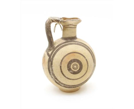 A Cypro- Archaic full bellied pitcher, with trefoil lip, ring foot and strap handle, with black banded detail, 29cm