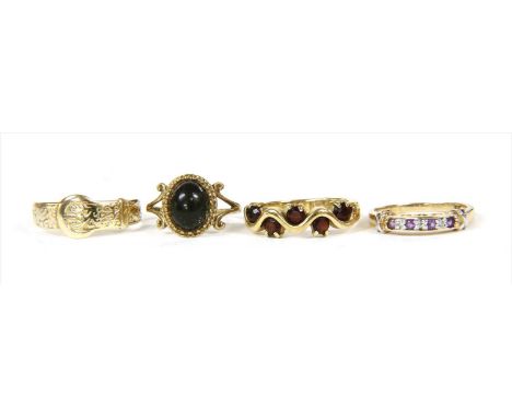 Four 9ct gold rings, to include a buckle ring, Sheffield, finger size R ½, a garnet dress ring, London 2001, finger size O, a