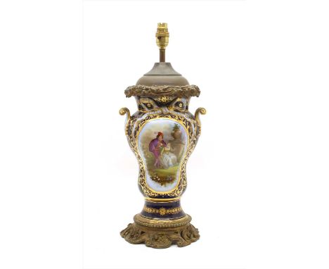 A Continental porcelain lamp base, the twin handled baluster body decorated on one side with a panel of a scene of a young co