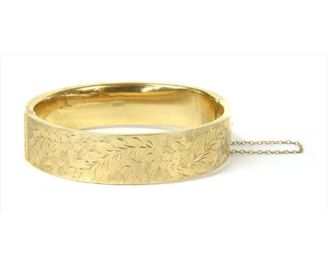 A 9ct gold hollow hinged bangle, by Cropp &amp; Farr, with floral hand engraving to the upper half, to concealed box clasp an
