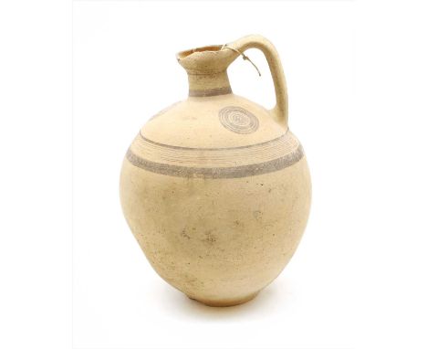 A Cypro- Archaic globular bellied flask, with trefoil lip and strap handle, with painted decoration of circles and concentric