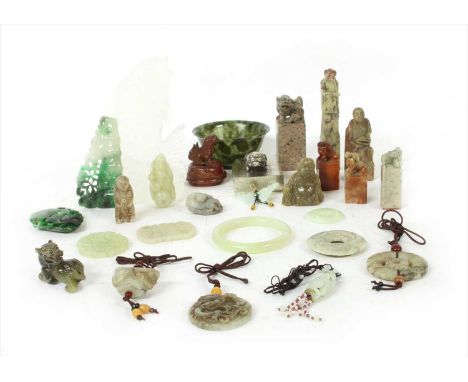 A collection of Chinese jade and hard stone carvings, with figures and mythical beasts, a hard stone carving of a carp, and a