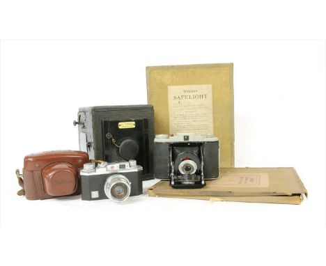A 'The Sickle Reflex de Luxe' camera , together with a Kodak 66 model II, and a Halina 35x