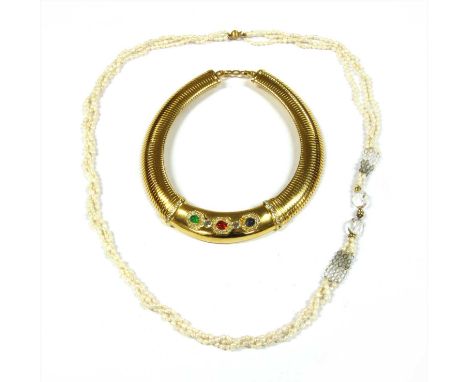 A gilt metal Christian Dior collar, a solid curved centrepiece set with green, blue, red and colourless paste, to an oval tub