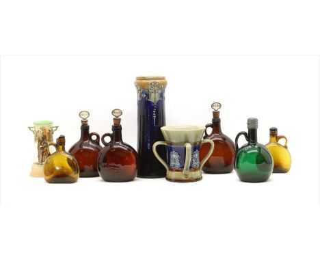 A group of flagon form decanters, mid 19th century, three amber examples, with cork and mother of pearl stoppers, a similar e