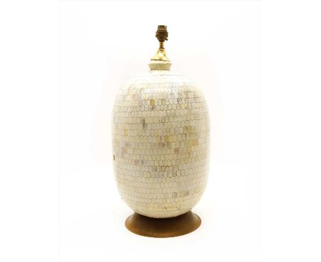 A modern table lamp of egg shaped form , having all over geometric shell decoration