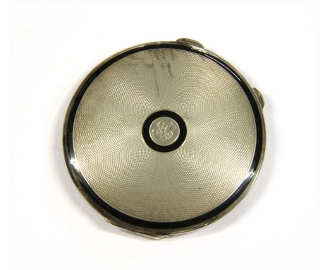 An Art Deco sterling silver compact, by Cohen &amp; Charles, with engine turned decoration and black enamel borders, London 1