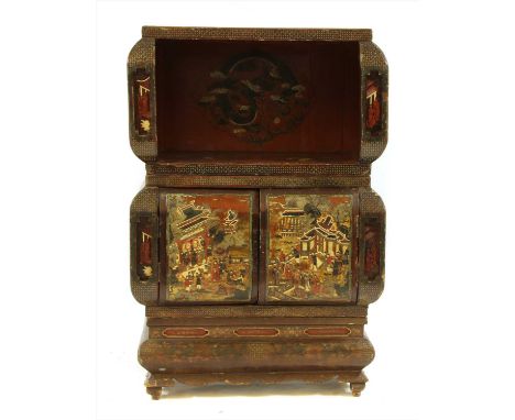 A Chinese sectional lacquer cabinet, decorated with birds on branches, a dragon chasing the flaming pearl, phoenix, figures i