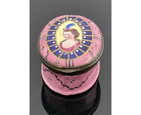 A Bilston enamelled patch box, circa 1780, oval, painted with a central portrait of a woman within blue panelled gilt frame, 