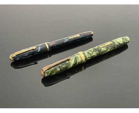 Conway Stewart, a number 84 fountain pen and a Dinkie 550 fountain pen, each with 14 carat gold nibs, marbled green and marbl
