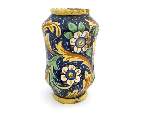 An Italian Maiolica albarello pharmacy jar, probably 17th century, waisted shouldered form, polychrome decorated with foliate