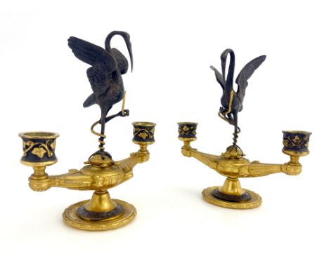 Ferdinand Barbedienne, a pair of bronze and ormolu figural candelabra, modelled as twin sconced Roman lamps, each with a cent