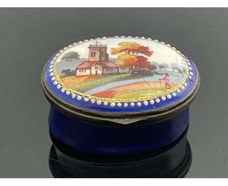 A Bilston enamelled patch box, circa 1790, oval, painted with a pastoral scene with figure and church, blue ground, mirrored 