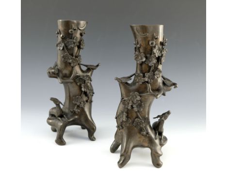 A pair of Japanese bronze root vases, cast in relief with deer, birds and branches, on four feet, 26m high (2)