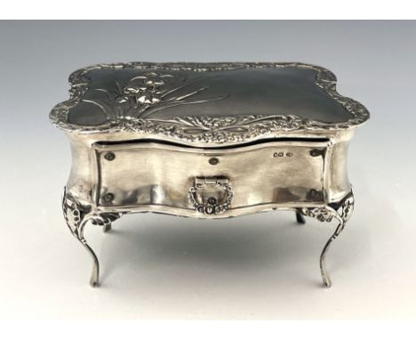 An Arts and Crafts silver jewel casket, William Comyns, London 1905, serpentine bombe table form, embossed in the Art Nouveau
