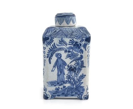 A Dutch Delft blue and white tea caddy, 18th century, cuboid form, painted with Chinese style figures amongst trees, below a 