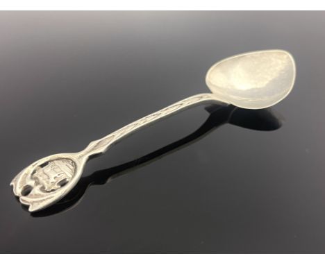 A E Jones, an Arts and Crafts silver spoon, Birmingham 1916, the spade form bowl on a chevron cast stem and open foliate shie