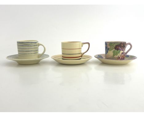 Susie Cooper, three Art Deco and Gray's Pottery coffee cans and saucers, including concentric ring examples, floral etc. (3)
