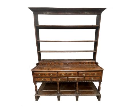 A George III country oak dresser, circa 1770 and later, triple tier plate rack with plain cornice, metal hooks, raised back i