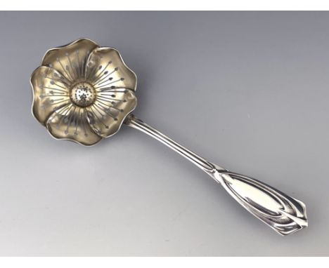 A Secessionist silver strawberry sugar sifter spoon, Austrian import marks circa 1905, the parcel gilt bowl pierced and model