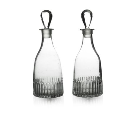 A pair of Anglo Irish glass spirit decanters, circa 1775, tapered form with moulded fluting and lemon squeezer bases, lozenge