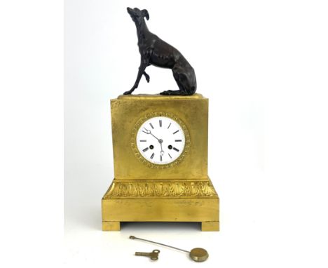 A French ormolu bracket clock, circa 1870, surmounted with a bronze model of a seated greyhound, white enamel dial with Roman