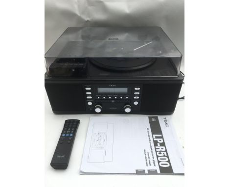 A TEAC LP 500 CD recorder with turntable and cassette player. Comes with remote control and owner's manual.