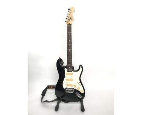 A Fenix by Young Chang black Stratocaster copy electric guitar. This electric guitar made circa 1990 was made by Fenix in Kor