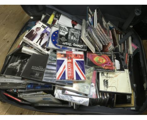 A suitcase containing CDs by various artists including Eric Clapton, Michael Jackson and others.