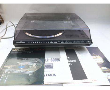 A vintage Aiwa LP3000 record player with owner's manual and related paperwork.