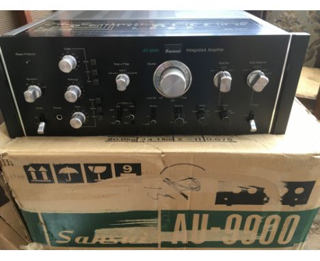 A boxed vintage Sansui AU9900 integrated amplifier with original owner's manual.