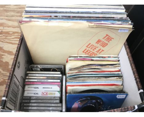 A box of LPs, 7 inch singles and DVDs. Various artists including The Who, Black Sabbath, David Bowie and others.