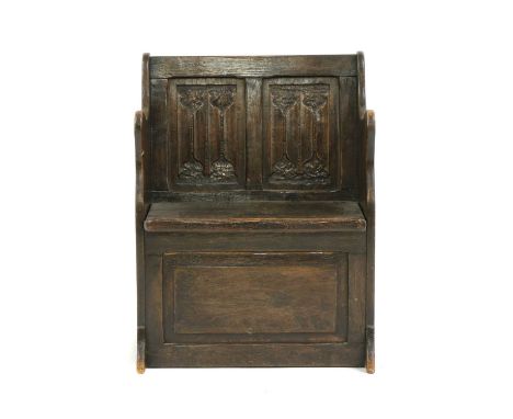 A small oak monks bench, early 20th century, the two panel linen fold back, over a box seat with lifting lid, 59cm wide, 36cm