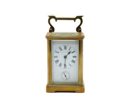 A French brass carriage clock, the white porcelain dial with Roman numerals, striking on a bell, 7.5cm wide, 7cm deep, 12cm h