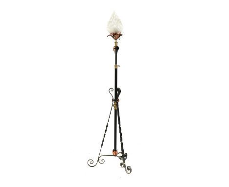 A wrought iron, copper and brass telescopic standard lamp, with scrolling foliate detail and raised on tripod supports, fitte