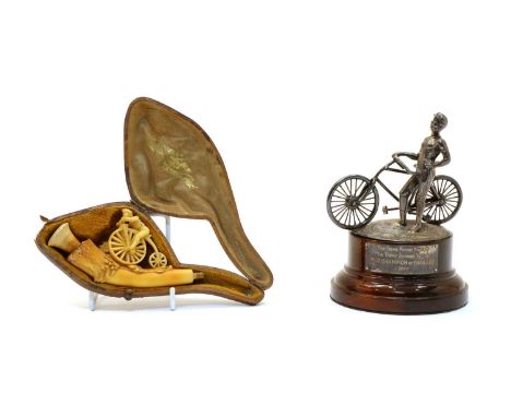 Cycling interest - a silver trophy finial and a meerschaum pipe, the finial now mounted on an ebonised base with plaque '....