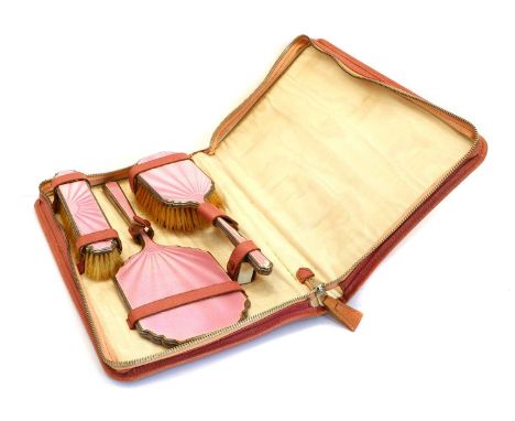 A silver and pink guilloche enamel cased dressing table set, comprising of a clothes brush, hair brush and a bevelled glass h