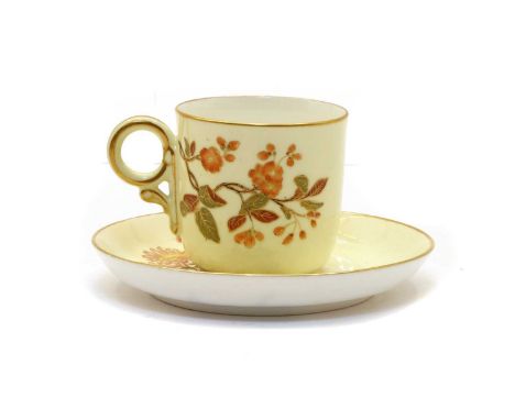 A Royal Worcester porcelain cabinet cup and saucer, the cream ground hand-painted with floral detailing, 'Made for Wright Ray