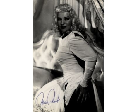 WEST MAE: (1893-1980) American Actress &amp; Sex Symbol. Vintage signed postcard photograph of West in a three quarter length