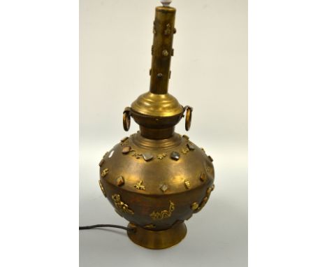 AN ORIENTAL BRASS CONVERTED LAMP, of bulbous form with applied Buddha, floral and hardstone decoration, engraved banding deco