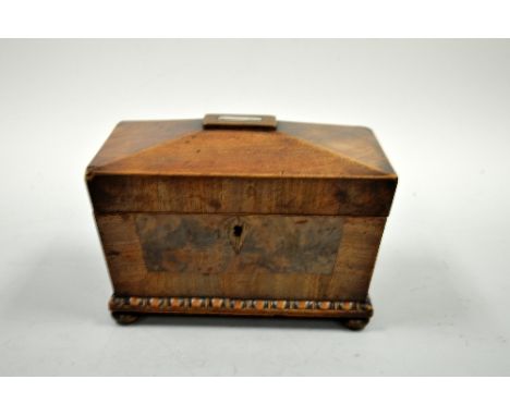A SARCOPHAGUS SHAPED MAHOGANY TEA CADDY, with mother of pearl inlay to hinged lid revealing lidded two division interior, bea