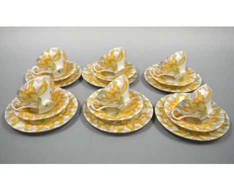 A ROYAL DOULTON ART DECO PART TEA SERVICE, (1932), in yellow, lilac and green floral design, comprising six trios, sugar, mil