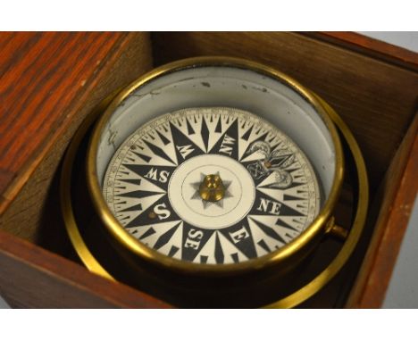 A BRASS GIMBAL MOUNTED SHIPS COMPASS, approximately 14cm diameter, in oak case