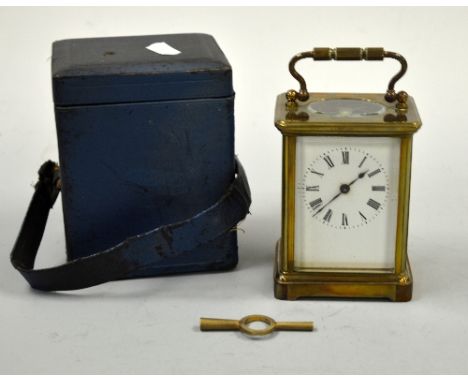 A BRASS CARRIAGE CLOCK, circular chapter ring with Roman numerals, swing loop handle, bracket foot base, case approximately 1