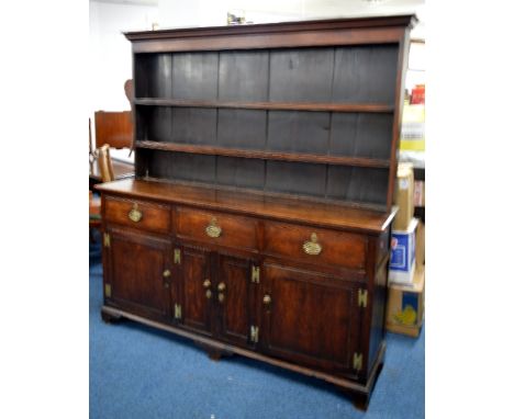 A 19TH CENTURY OAK AND MAHOGANY DRESSER, with three deep drawers over four cupboards to base with three shelf plate rack over