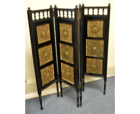 AN EBONISED FOUR FOLD SCREEN, each rectangular panel with triptych needlework with scarab shells in floral and scroll decorat