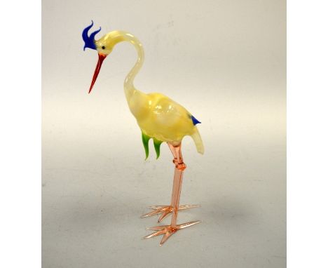 A HAND BLOWN GLASS STORK, with opaque yellow body, blue comb and tail feathers, approximately 28cm high