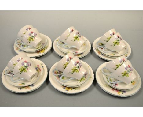 A SHELLEY WILD FLOWER PART TEA SERVICE, comprising eleven trios, cup and side plate, milk, sugar and bread and butter plate, 